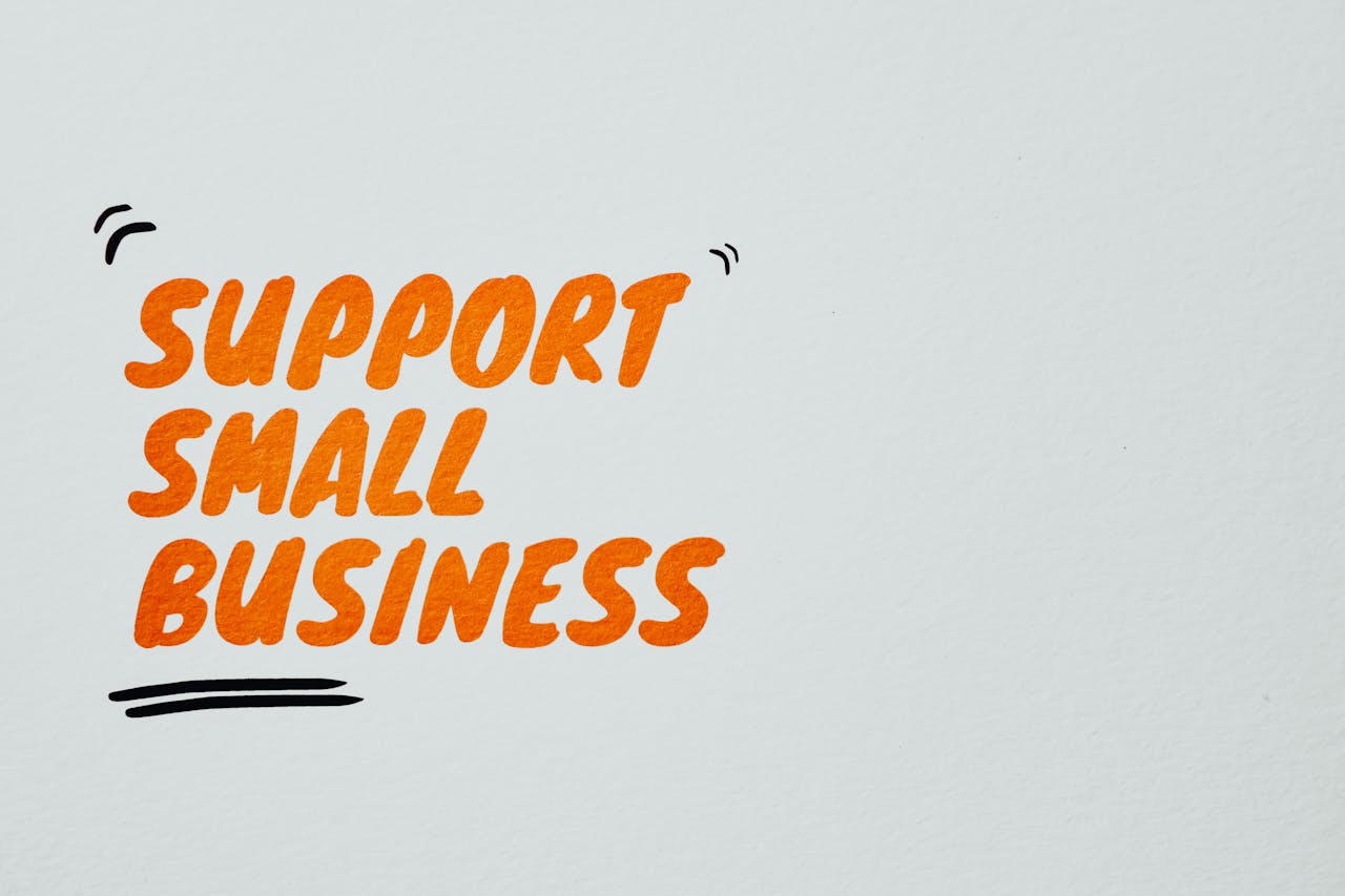 Support Small Business Text on a White Surface